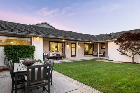 a view of a house with a backyard
