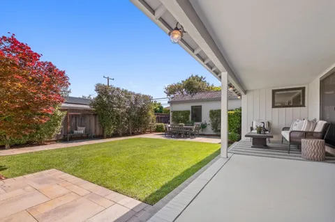 a view of a house with swimming pool and sitting area
