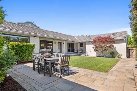 a view of a patio with table and chairs and potted plants