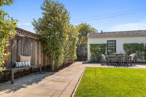 a view of backyard with outdoor seating and green space