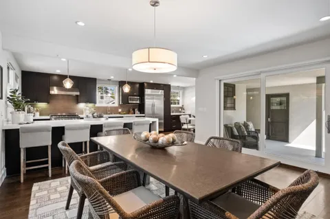 a kitchen with a dining table and chairs