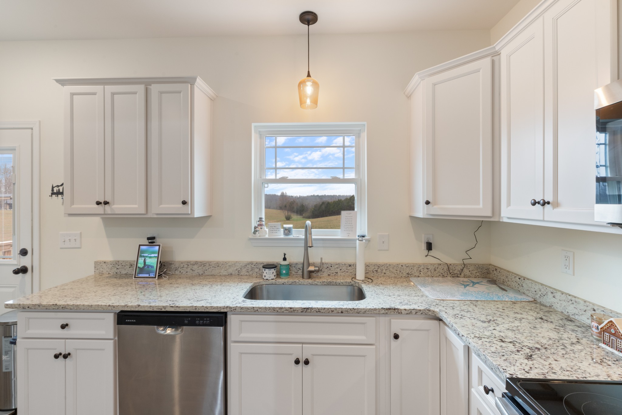 1159 Oak Grove Road Dickson, TN 37055 - Photo 12 of 29 a kitchen with granite countertop a sink stainless steel appliances white cabinets and a window