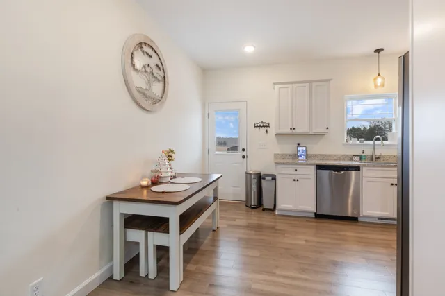 a kitchen with a stove cabinets and wooden floor
