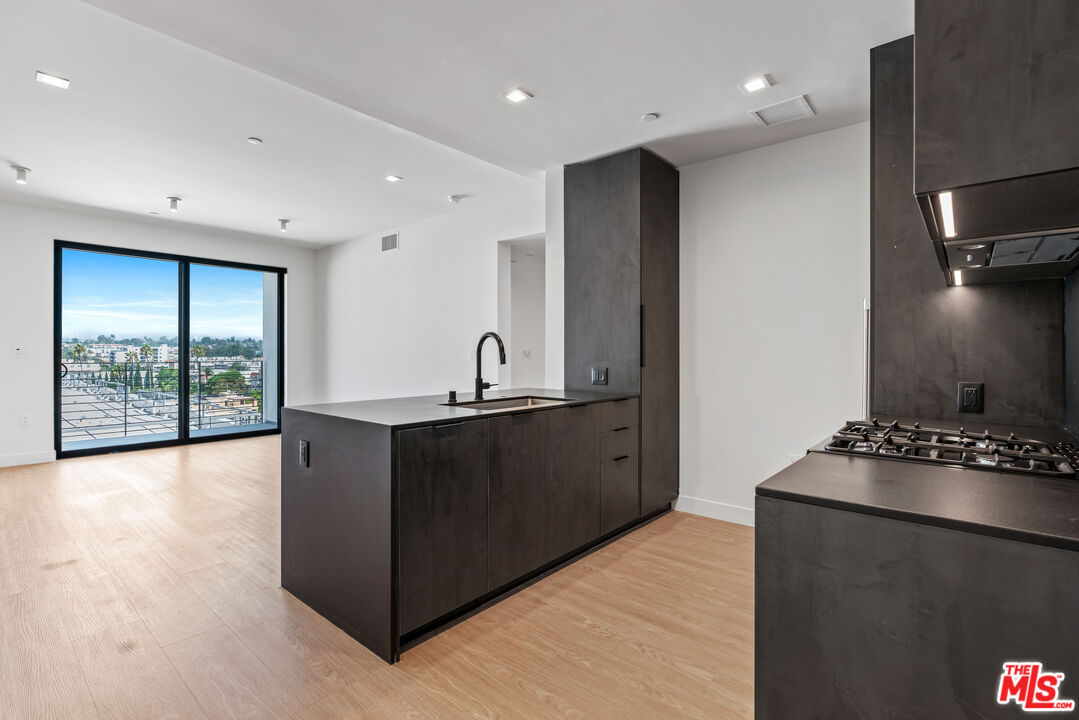 a kitchen with stainless steel appliances granite countertop a refrigerator and a stove