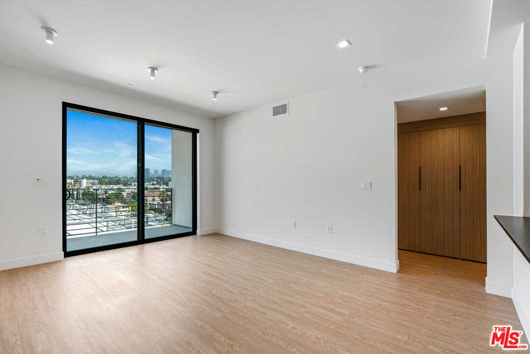 3688 Overland Avenue, Unit PH21 Los Angeles, CA 90034 - Photo 4 of 14 wooden floor in an empty room with a window