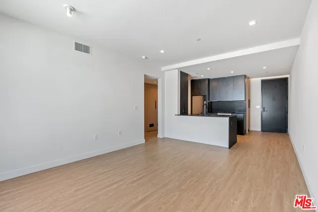 a view of kitchen with refrigerator microwave and wooden floor