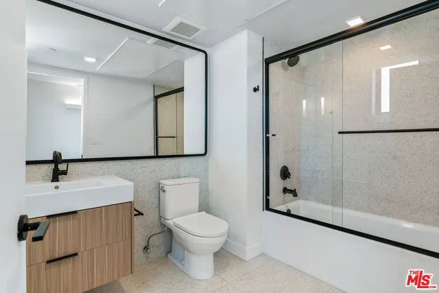 a bathroom with a toilet sink and shower