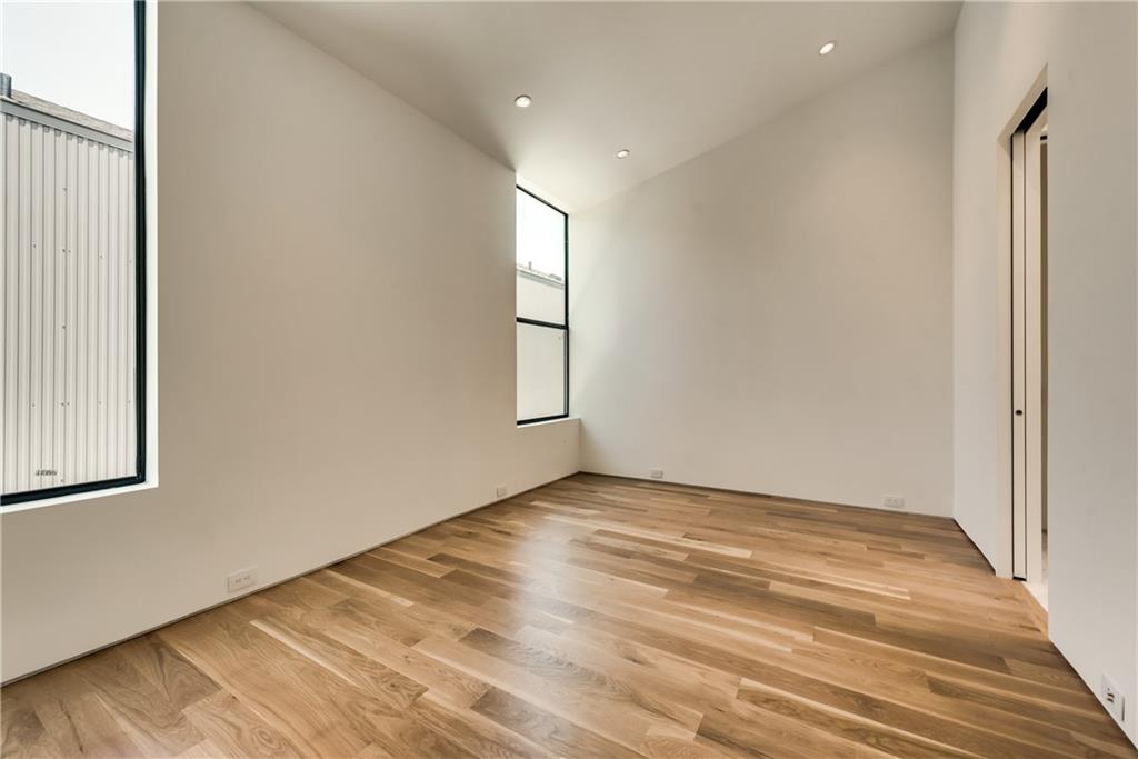 1504 Burlew Street, Unit 4 Dallas, TX 75204 - Photo 16 of 30 an empty room with wooden floor and windows