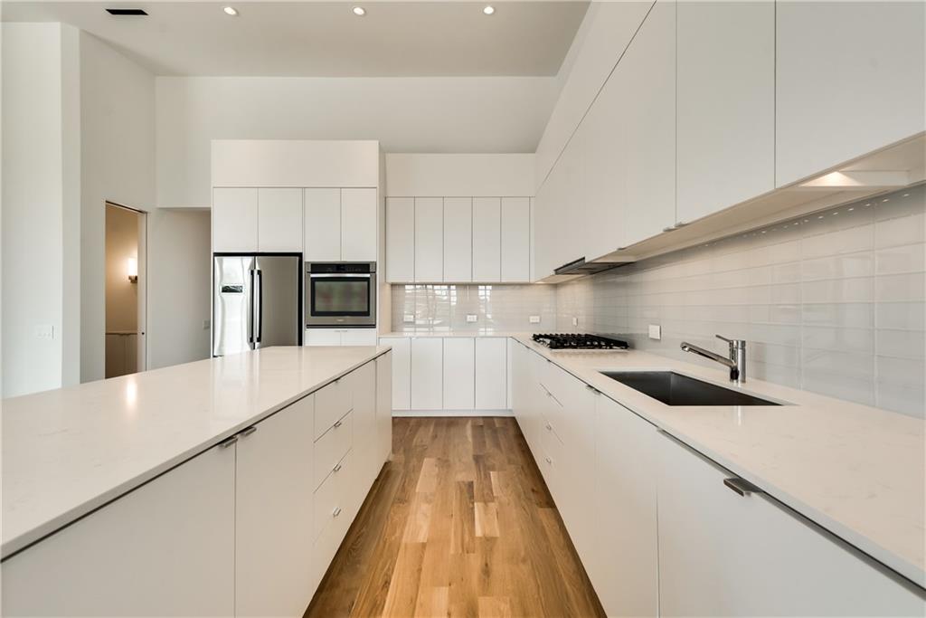 1504 Burlew Street, Unit 4 Dallas, TX 75204 - Photo 6 of 30 a kitchen with a sink and stainless steel appliances