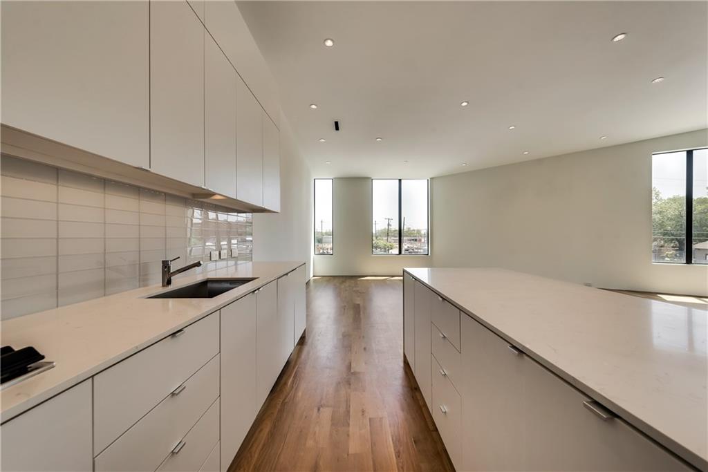 1504 Burlew Street, Unit 4 Dallas, TX 75204 - Photo 8 of 30 a large kitchen with a lot of counter space and wooden floor