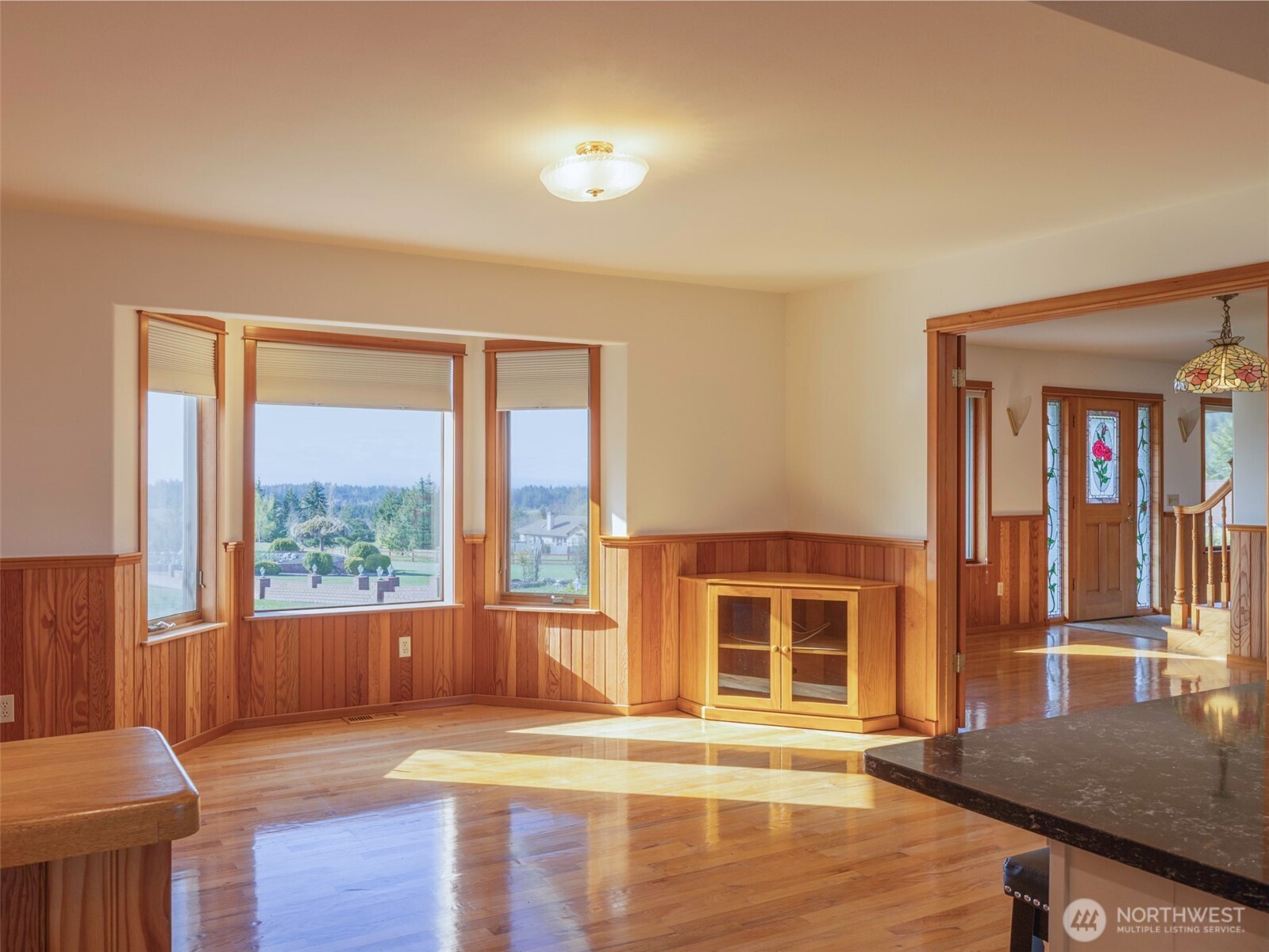 2594 Happy Valley Road Sequim, WA 98382 - Photo 11 of 35 a view of an empty room with wooden floor and a window