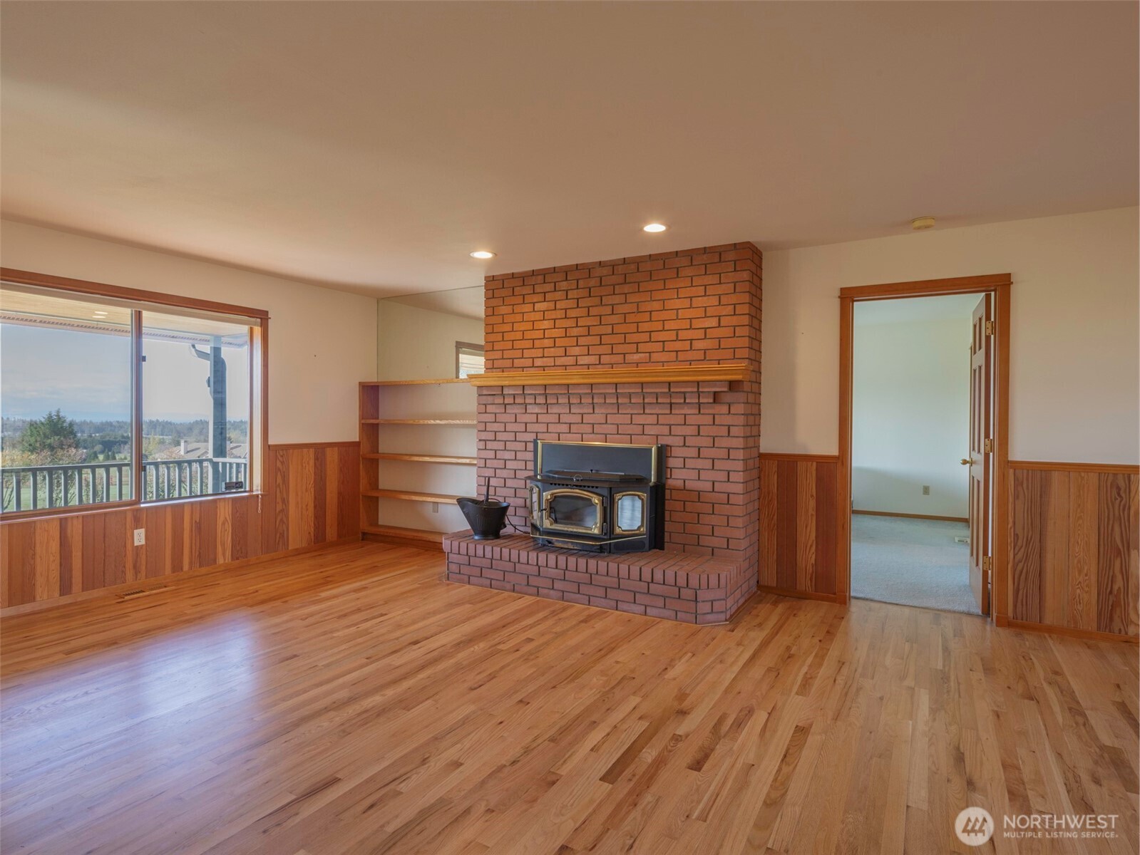 2594 Happy Valley Road Sequim, WA 98382 - Photo 7 of 35 wooden floor fireplace and windows in an empty room
