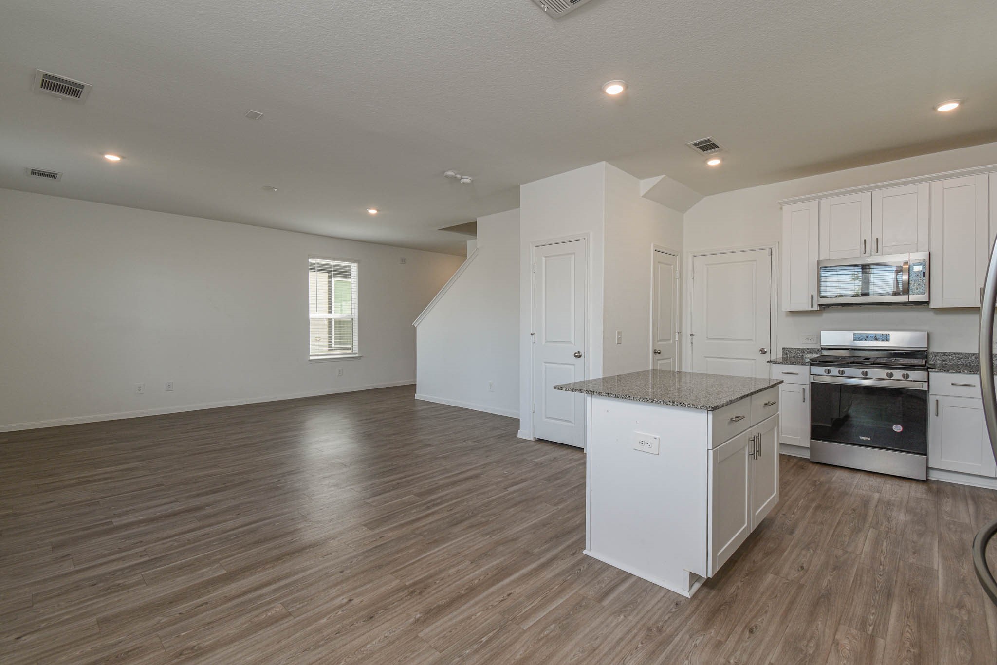 5727 Finely Run Street Spring, TX 77373 - Photo 4 of 26 a kitchen with stainless steel appliances granite countertop a stove a sink and a refrigerator
