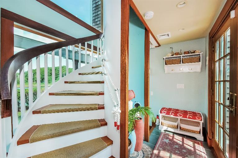 26 Short Beach Road Centerville, MA 02632 - Photo 14 of 34 a view of staircase with lots of frames on wall and a potted plant