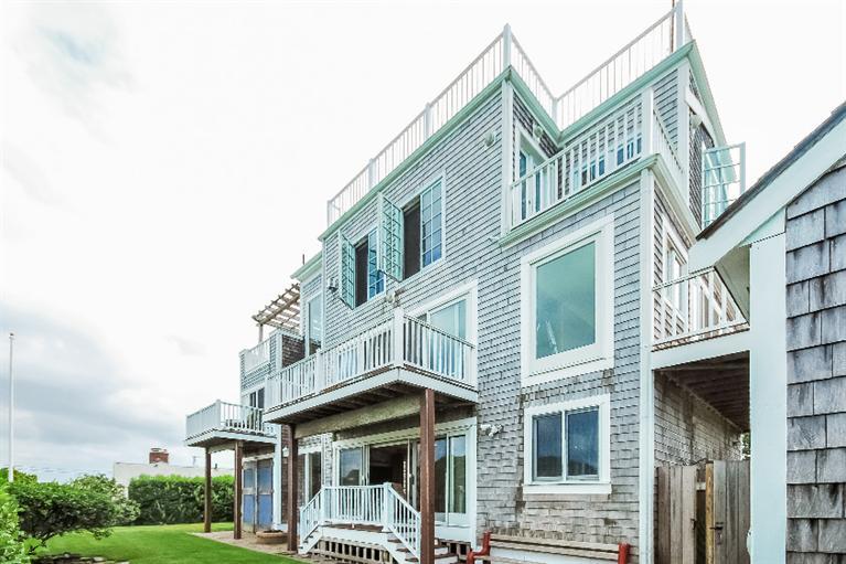 26 Short Beach Road Centerville, MA 02632 - Photo 3 of 34 a front view of a residential apartment building with a yard