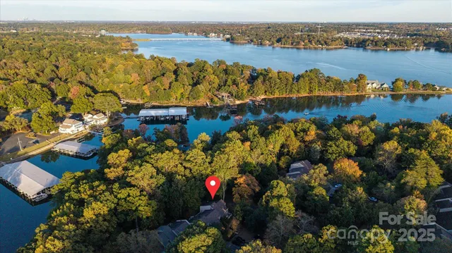 an aerial view of residential building with outdoor space and lake view