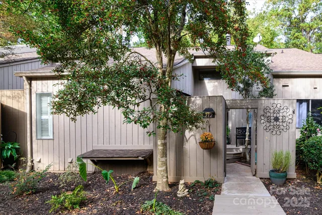 a house that has a tree in front of the house