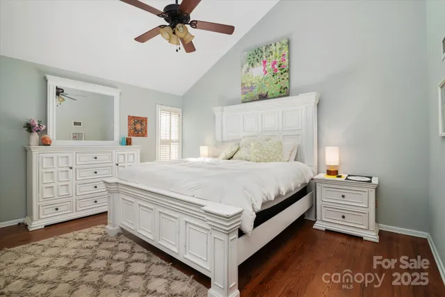 a spacious bedroom with a bed and a dresser