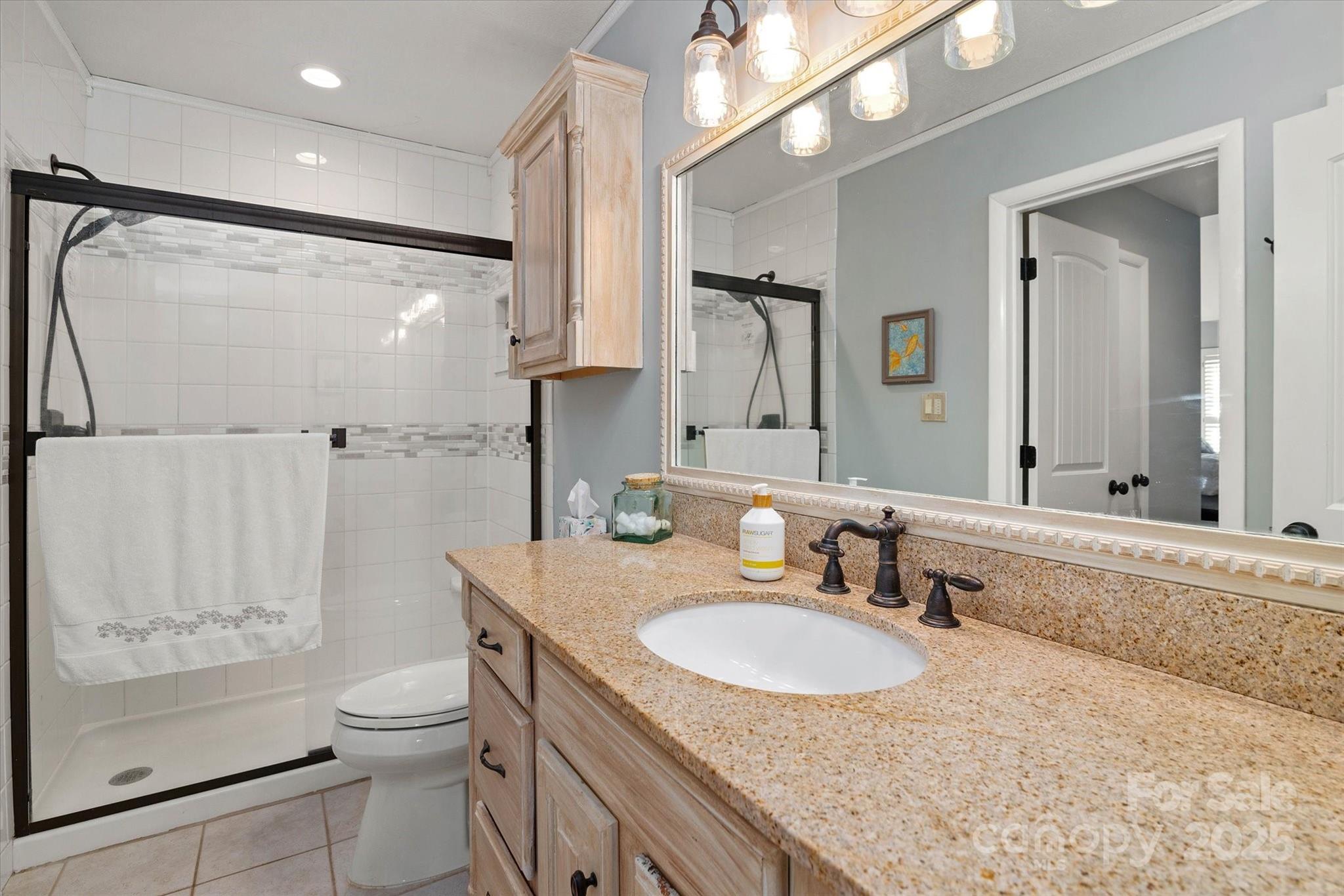 212 Riverview Terrace Clover, SC 29710 - Photo 28 of 48 a bathroom with a granite countertop sink toilet and shower