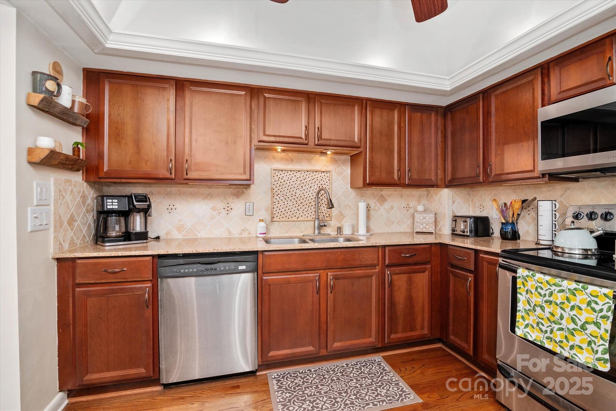 212 Riverview Terrace Clover, SC 29710 - Photo 33 of 48 a kitchen with granite countertop wooden cabinets and a sink