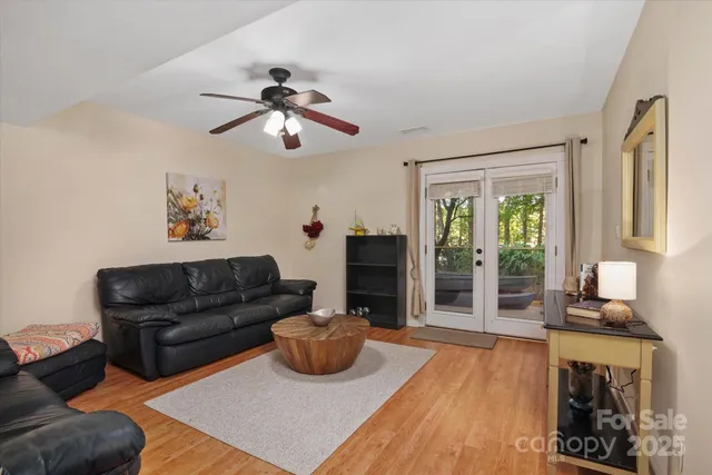 a living room with furniture and a wooden floor
