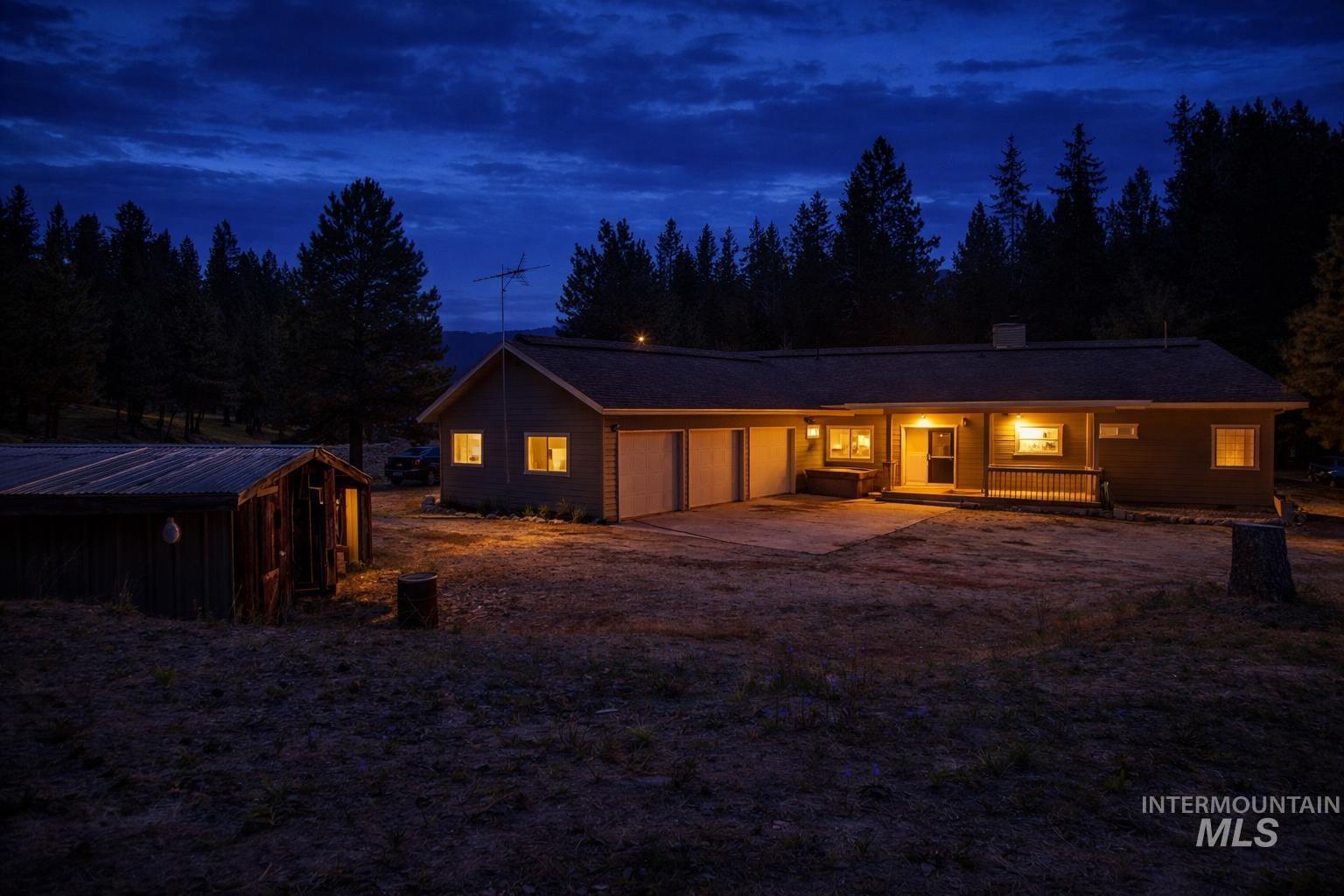 1126 Banks Lowman Road Garden Valley, ID 83622 - Photo 2 of 49 View of front of property with covered porch, an attached garage, driveway, and a chimney