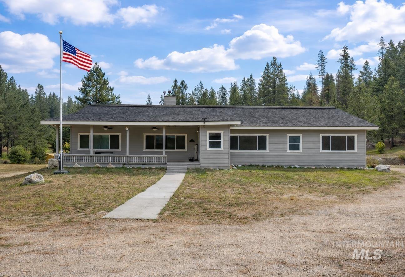 1126 Banks Lowman Road Garden Valley, ID 83622 - Photo 46 of 48 Ranch-style house with a porch, a chimney, roof with shingles, a ceiling fan, and a front lawn