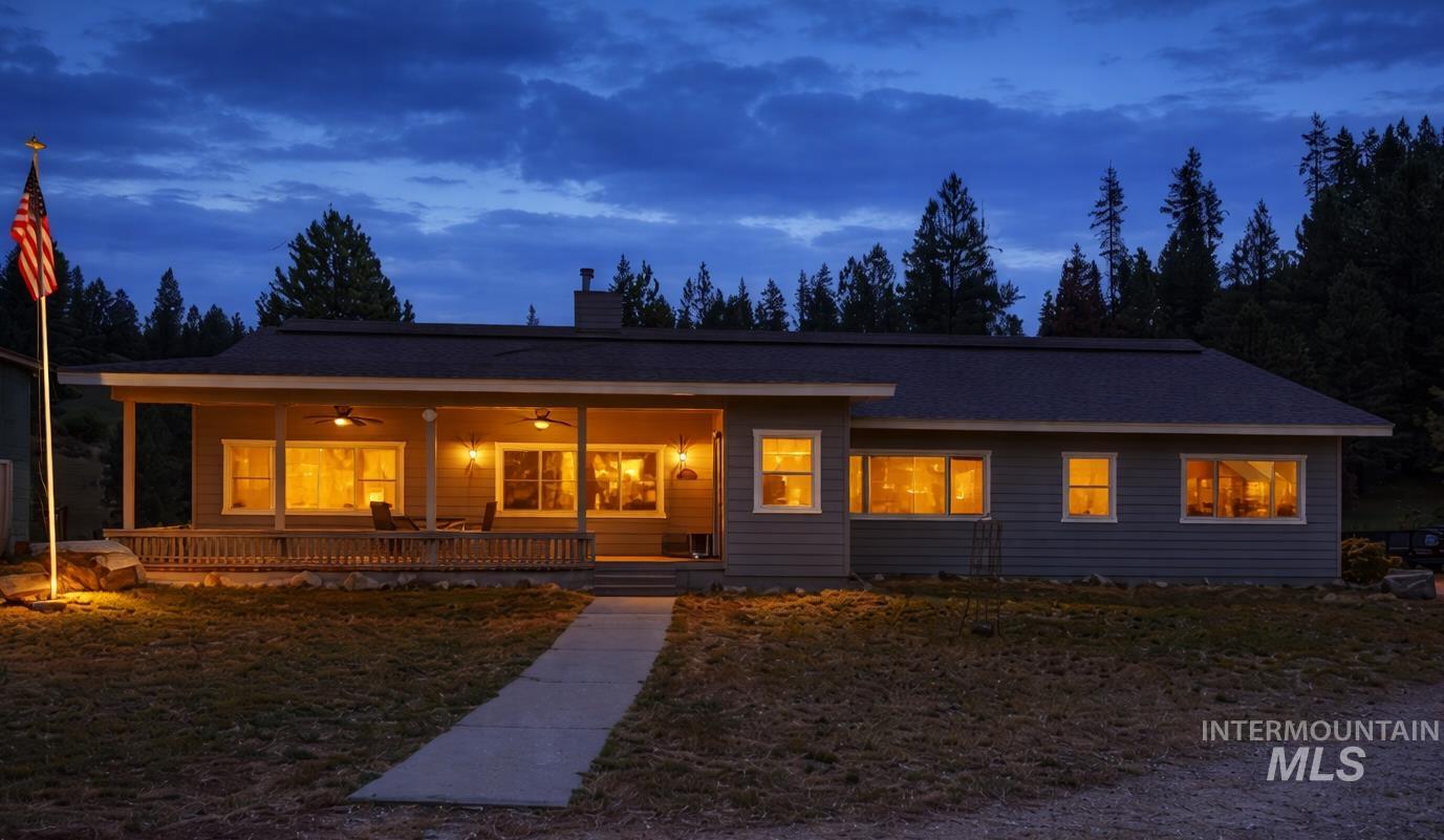 1126 Banks Lowman Road Garden Valley, ID 83622 - Photo 7 of 48 View of front of home with covered porch, a ceiling fan, a chimney, and a front yard