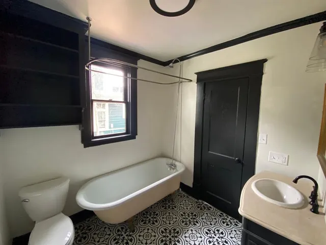 a bathroom with a tub toilet and sink