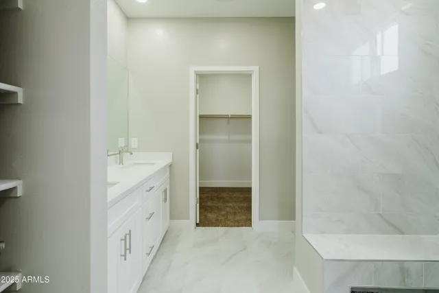 a bathroom with a granite countertop sink a toilet and shower