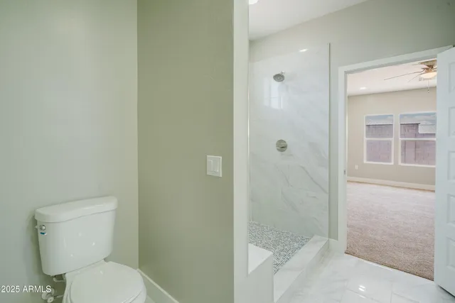 a white toilet sitting next to a bathroom sink