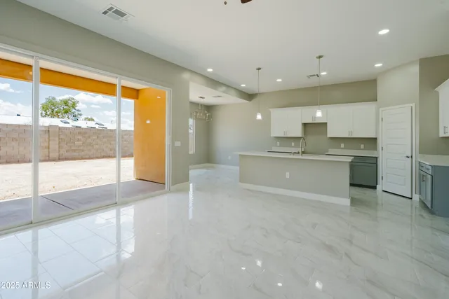 a large white kitchen with a large window