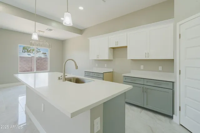 a kitchen with a sink a stove and cabinets