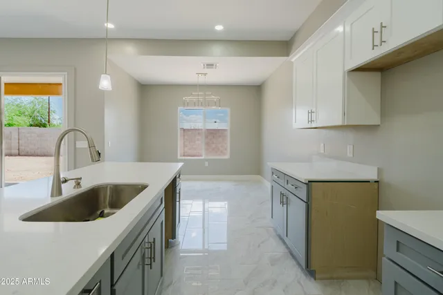 a kitchen that has a sink and a stove in it