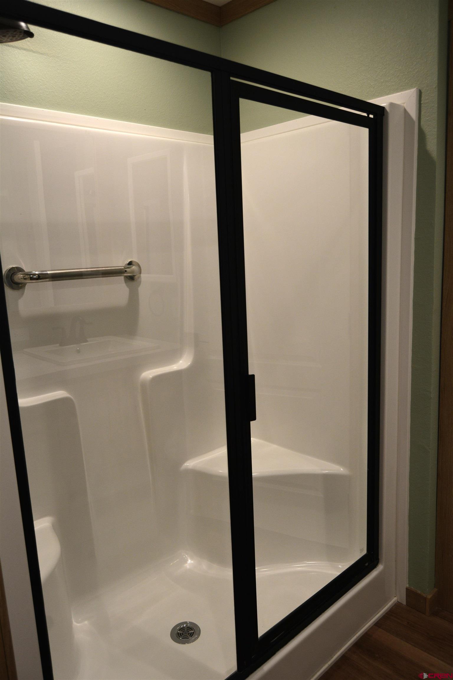 901 6530 Road, Unit 1030 Montrose, CO 81401 - Photo 12 of 22 a bathroom with a glass shower door