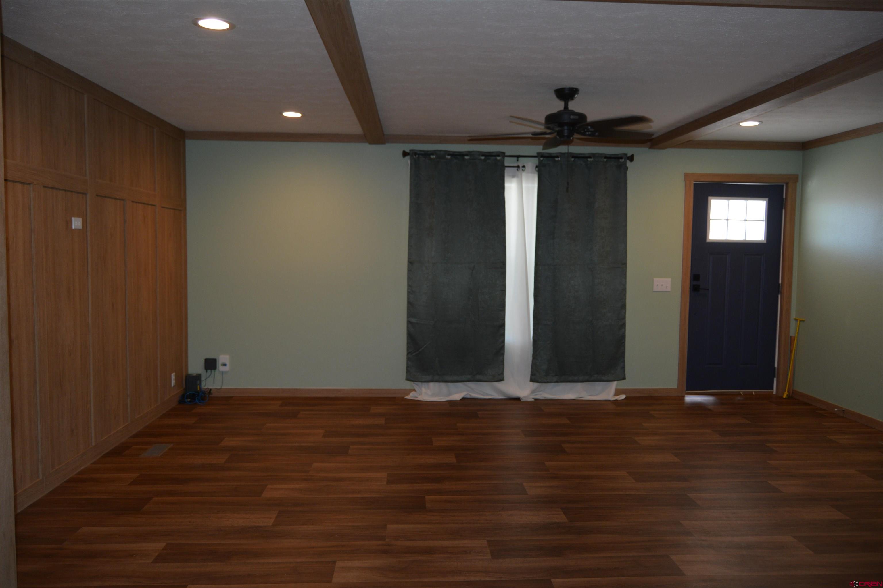 901 6530 Road, Unit 1030 Montrose, CO 81401 - Photo 16 of 22 an empty room with wooden floor and windows
