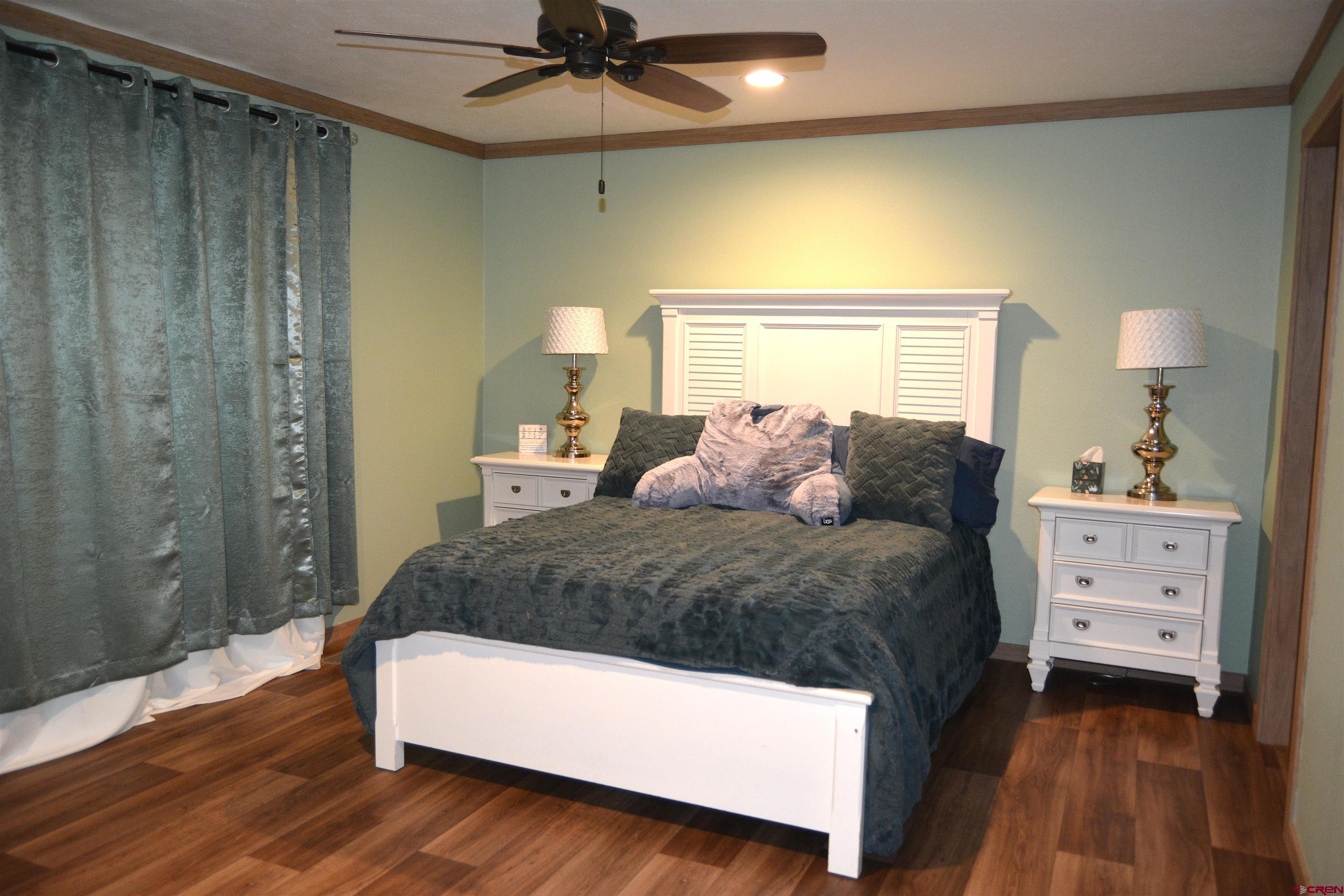 901 6530 Road, Unit 1030 Montrose, CO 81401 - Photo 9 of 22 a bedroom with a bed and a chandelier