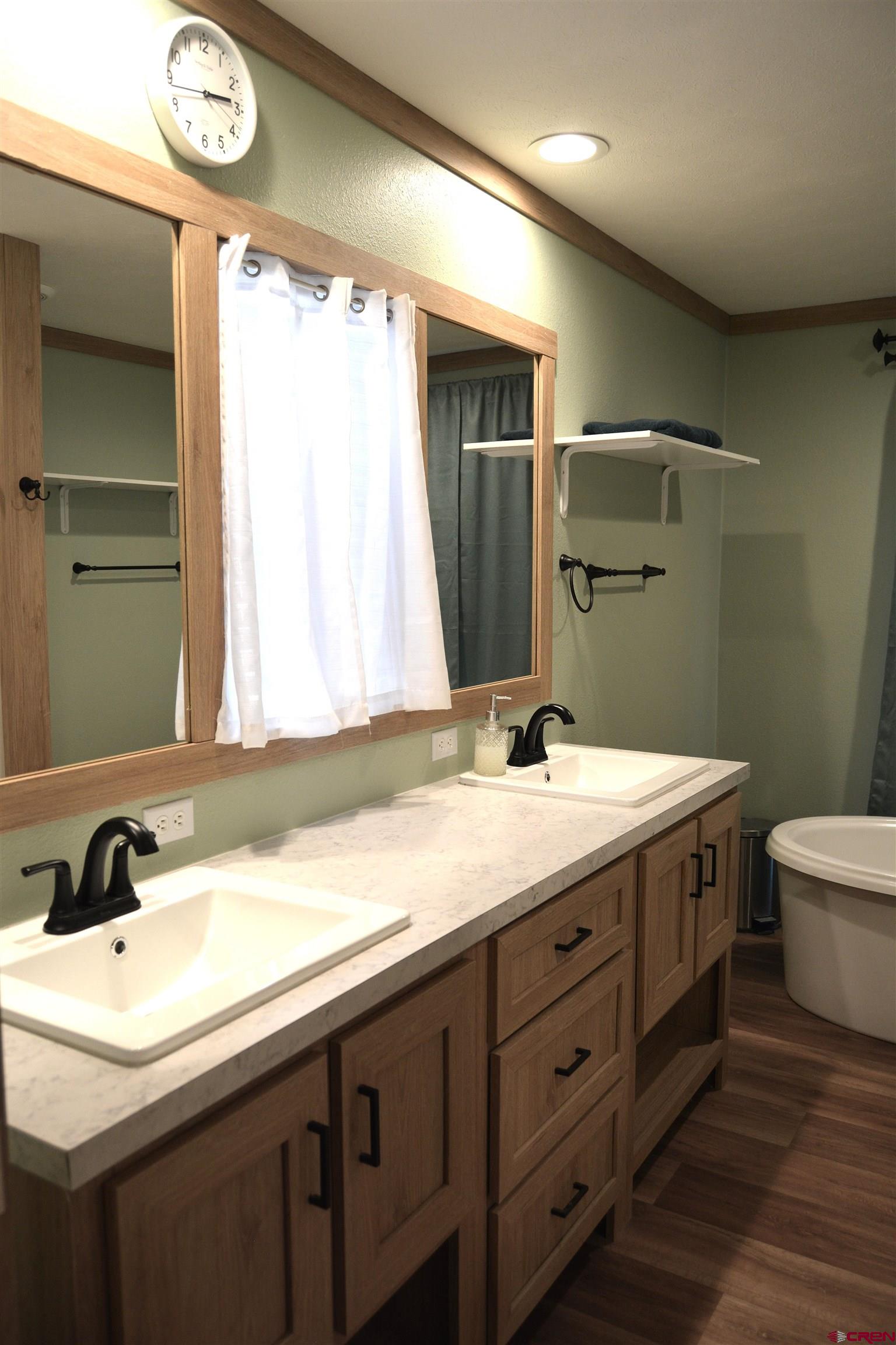 901 6530 Road, Unit 1030 Montrose, CO 81401 - Photo 10 of 22 a bathroom with a double vanity sink and a mirror
