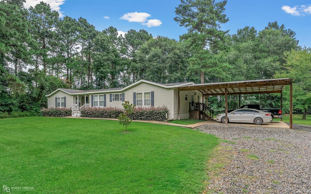 a view of a house with a backyard