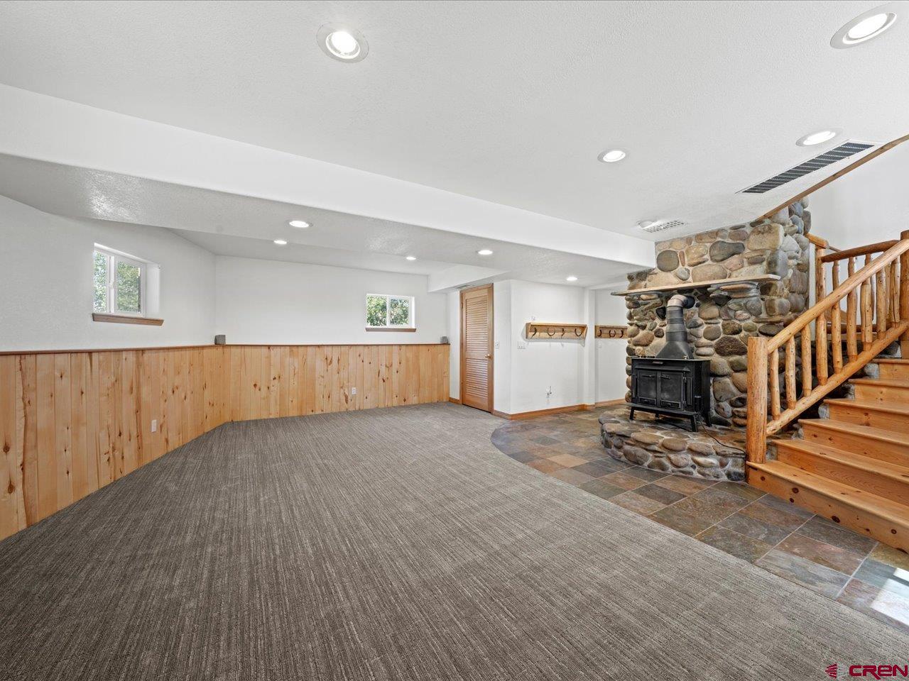 55 Valley View Road Ridgway, CO 81432 - Photo 21 of 40 an empty room with wooden floor and staircase