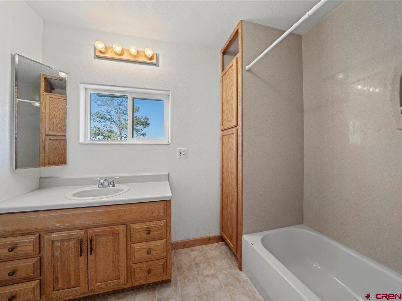 55 Valley View Road Ridgway, CO 81432 - Photo 25 of 40 a bathroom with a tub sink and mirror