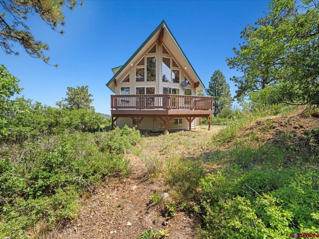 55 Valley View Road Ridgway, CO 81432 - Photo 40 of 40 a front view of a house with a yard and balcony