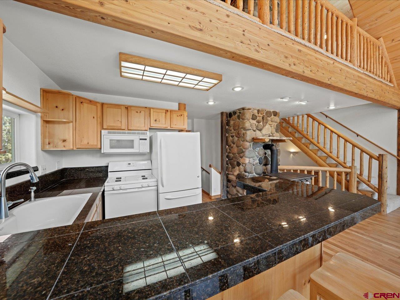 55 Valley View Road Ridgway, CO 81432 - Photo 9 of 40 a open kitchen with stainless steel appliances granite countertop a sink and cabinets