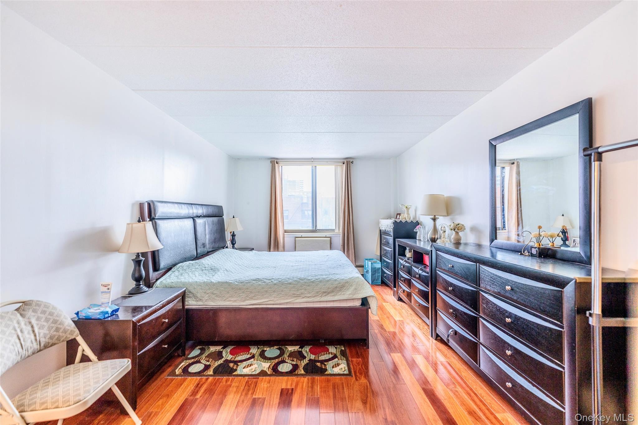 136-24 Maple Avenue, Unit 6F Queens, NY 11355 - Photo 10 of 29 a bed room with a bed and window