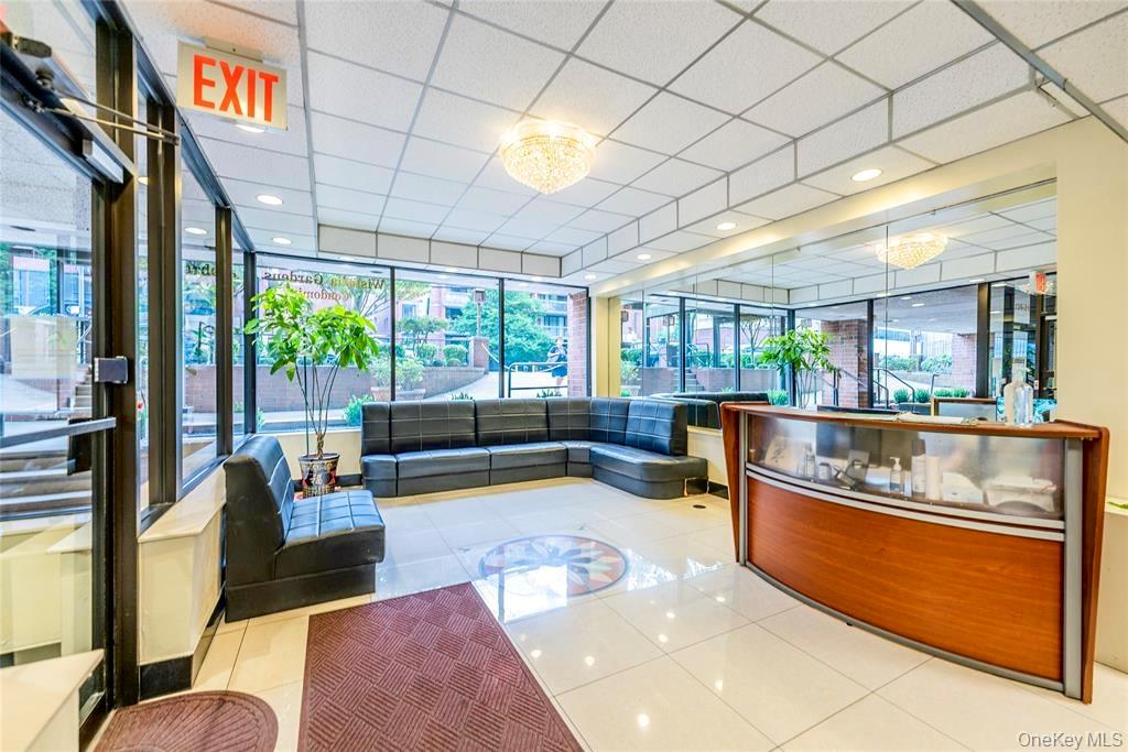 136-24 Maple Avenue, Unit 6F Queens, NY 11355 - Photo 17 of 29 a living room with furniture and a large window