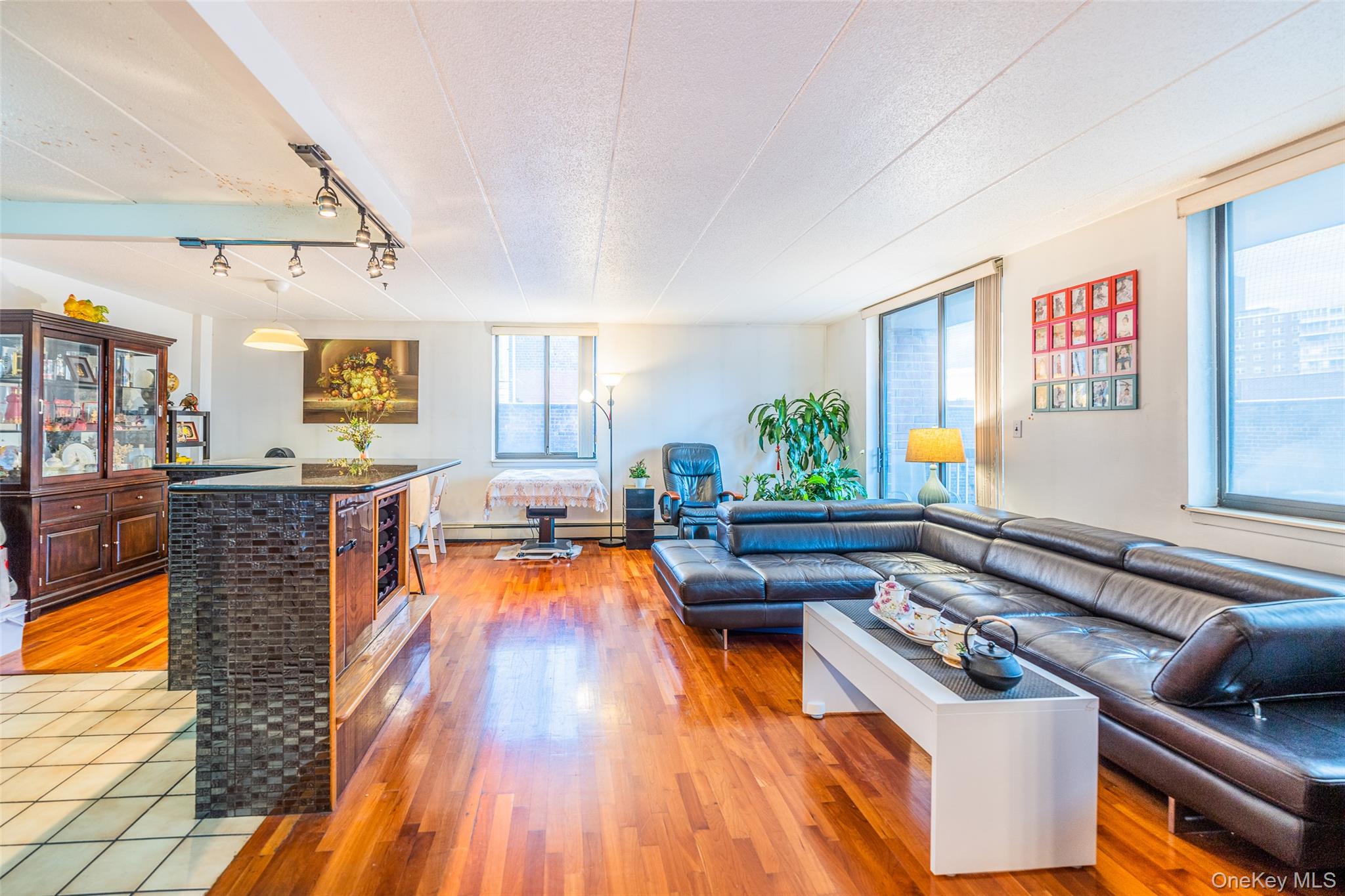 136-24 Maple Avenue, Unit 6F Queens, NY 11355 - Photo 2 of 29 a living room with furniture and a wooden floor