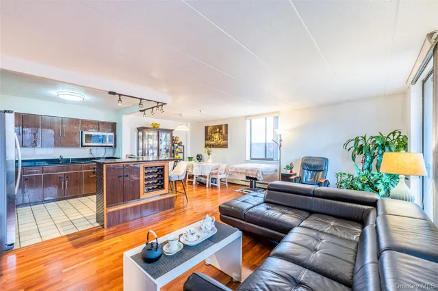 a living room with furniture and a wooden floor