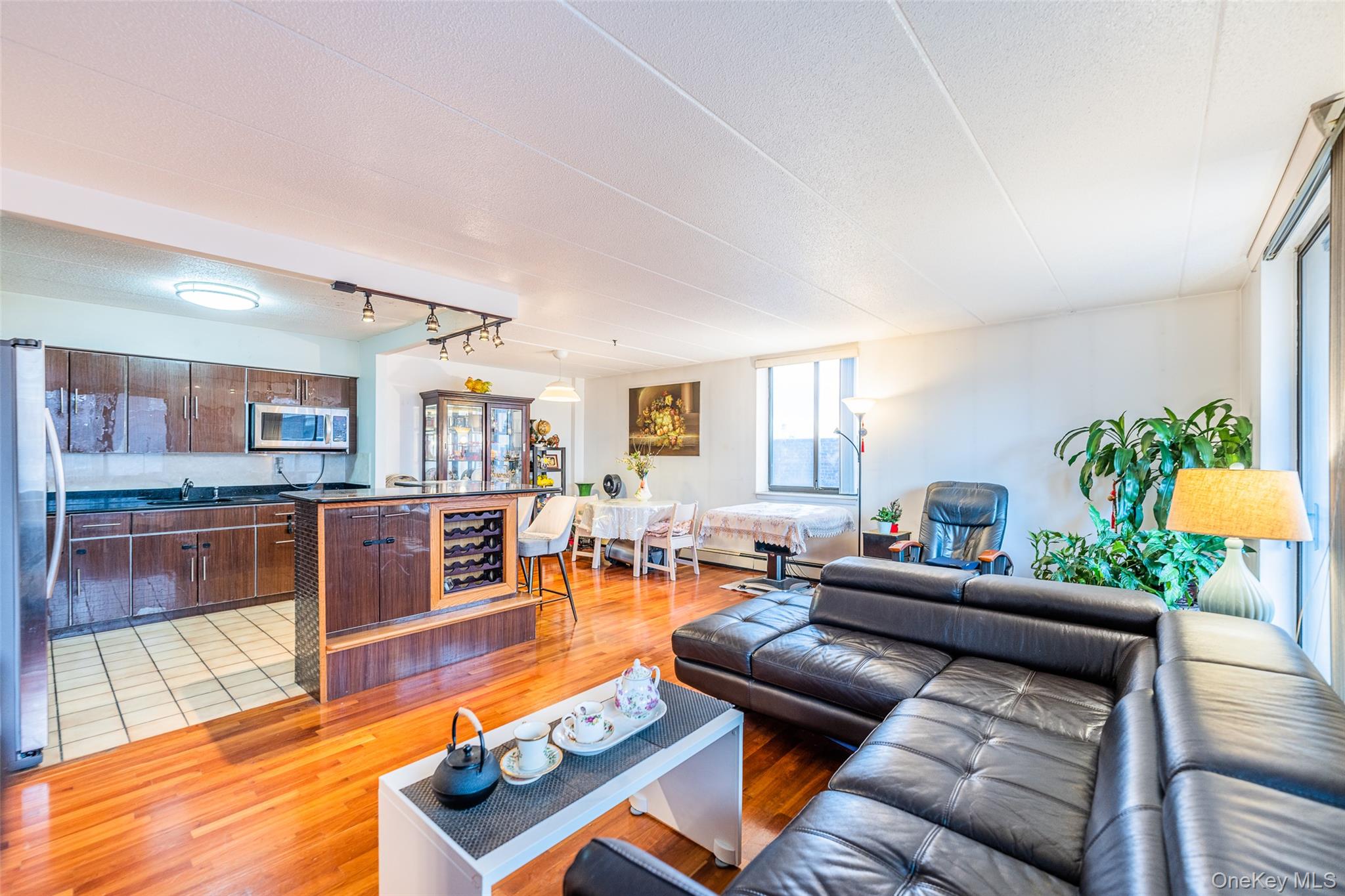 136-24 Maple Avenue, Unit 6F Queens, NY 11355 - Photo 3 of 29 a living room with furniture and a wooden floor