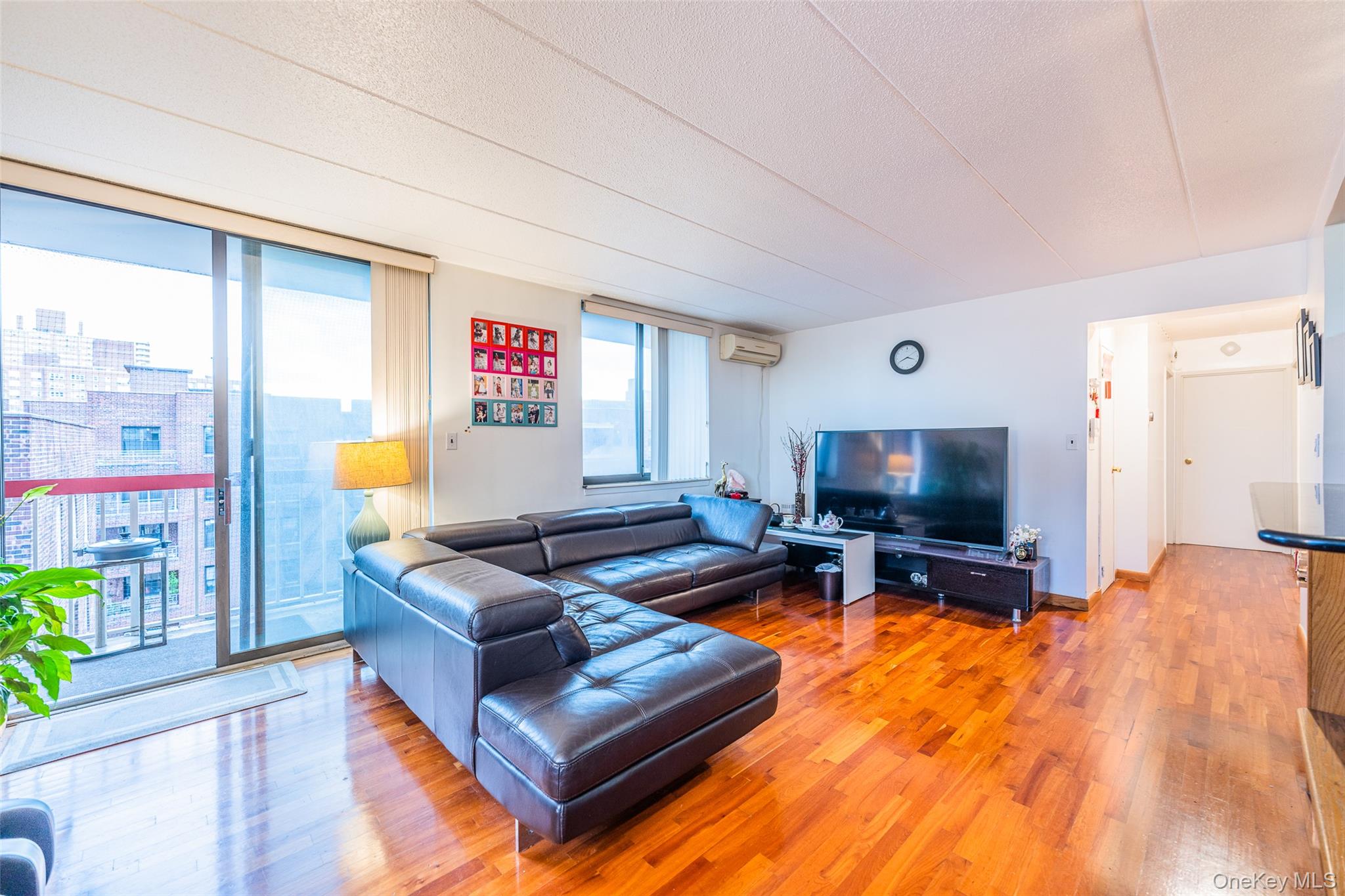 136-24 Maple Avenue, Unit 6F Queens, NY 11355 - Photo 7 of 29 a living room with furniture and a flat screen tv