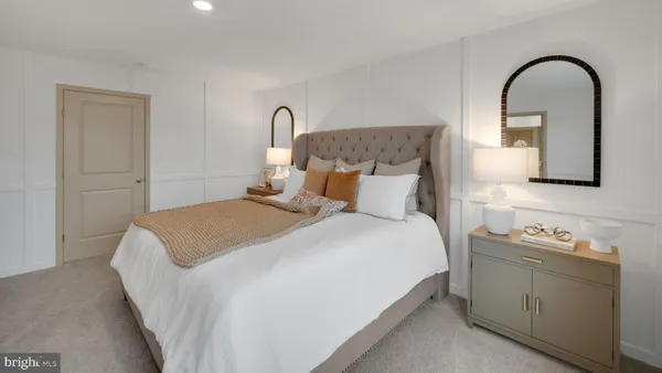 a bedroom with a bed and a dresser